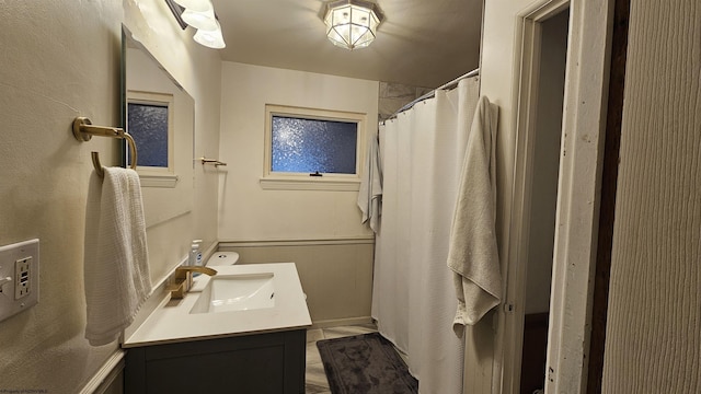 bathroom with curtained shower and vanity