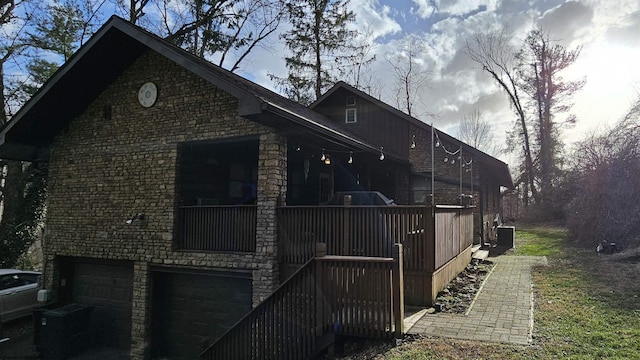 view of side of property featuring an attached garage