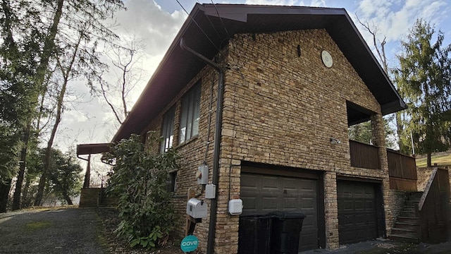 view of property exterior featuring stairway, a garage, and stone siding