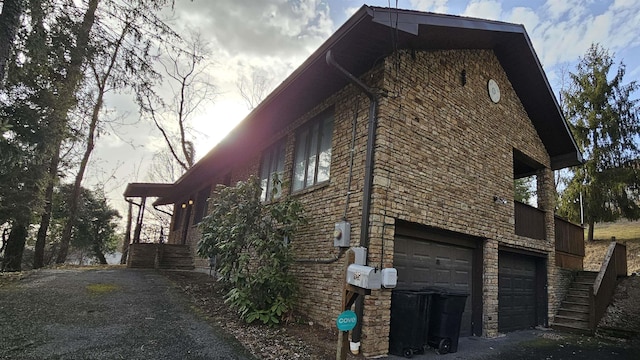 view of home's exterior with stone siding and an attached garage