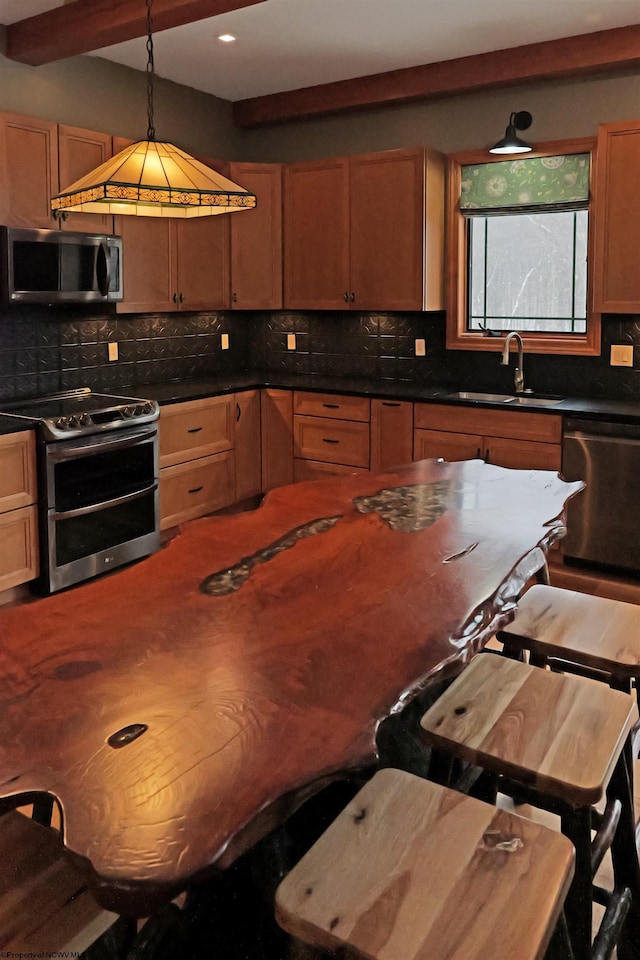 kitchen featuring decorative backsplash, dark countertops, and stainless steel appliances