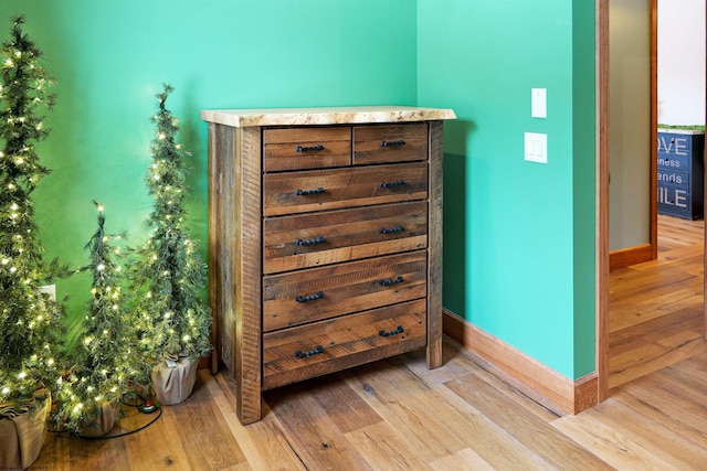 room details with baseboards and wood finished floors