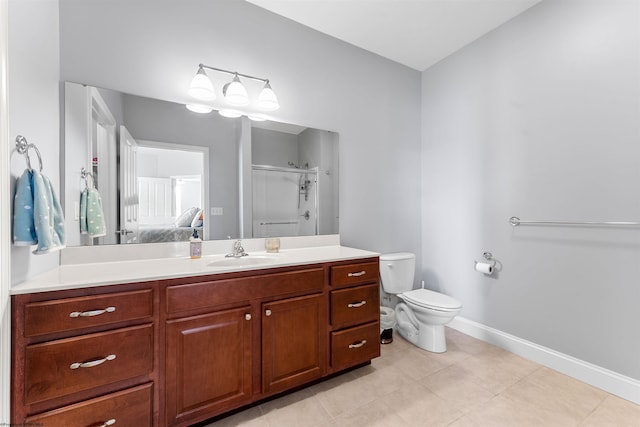 ensuite bathroom with toilet, a stall shower, tile patterned flooring, baseboards, and vanity