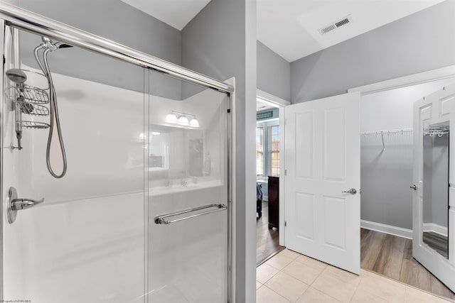 bathroom featuring visible vents, a stall shower, and tile patterned flooring