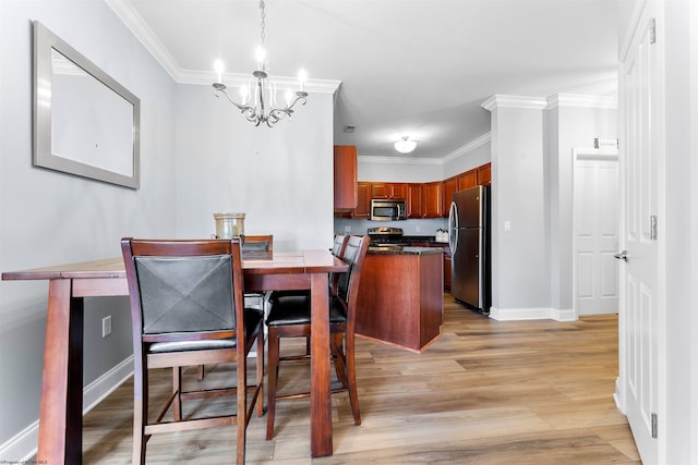 dining area with a chandelier, baseboards, light wood-style floors, and ornamental molding