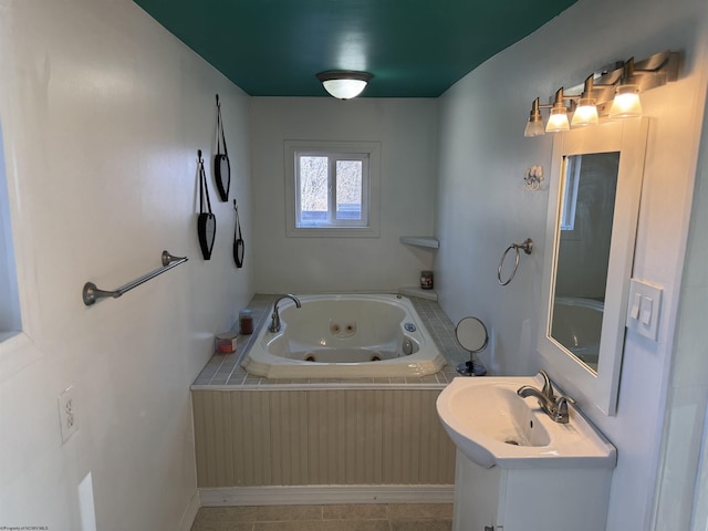 bathroom featuring a tub with jets and vanity
