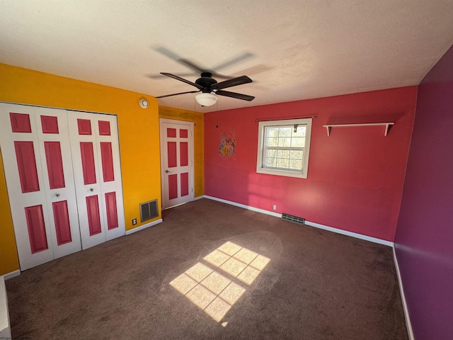 unfurnished bedroom with visible vents, a textured ceiling, a ceiling fan, and carpet floors