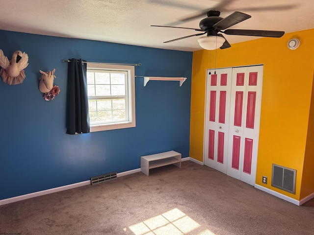 unfurnished bedroom featuring visible vents, carpet floors, and baseboards