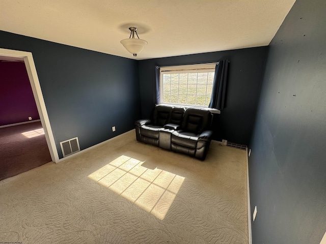interior space featuring a baseboard radiator, carpet, visible vents, and baseboards