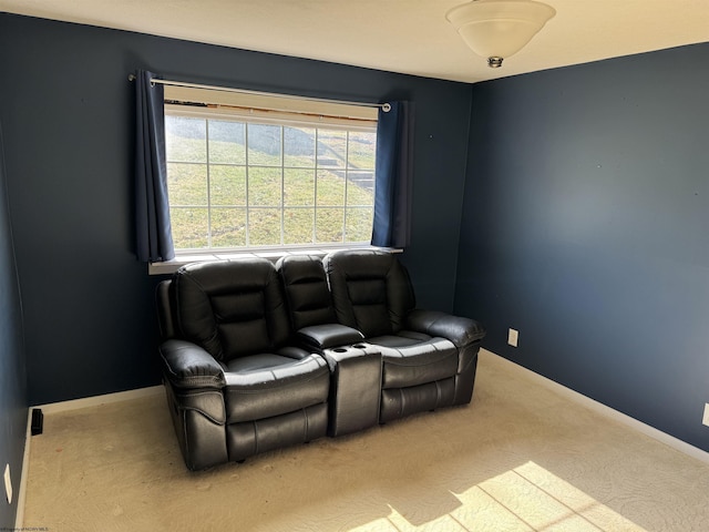home theater room featuring carpet and baseboards