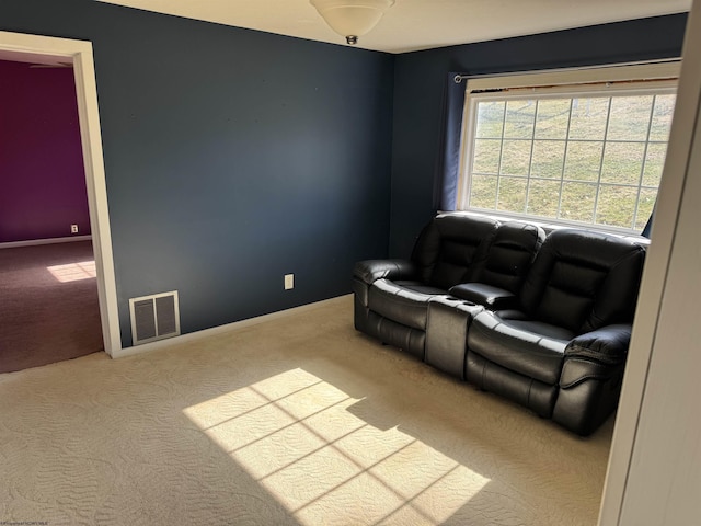 sitting room featuring baseboards, visible vents, and carpet floors