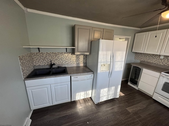 kitchen featuring dark wood-type flooring, ornamental molding, a sink, open shelves, and white appliances