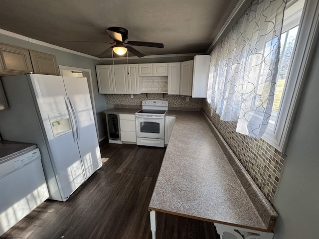 kitchen featuring tasteful backsplash, white appliances, crown molding, ceiling fan, and dark wood-style flooring