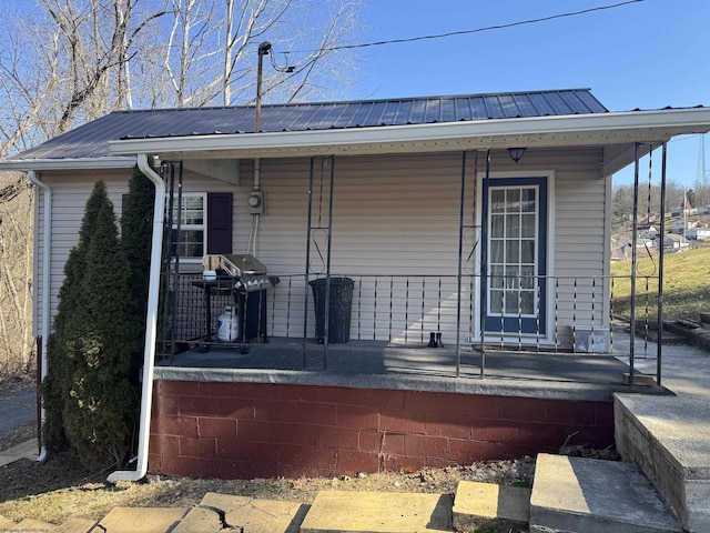 exterior space with covered porch and metal roof