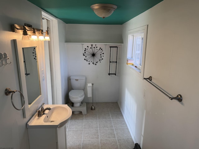 bathroom featuring tile patterned flooring, toilet, and vanity