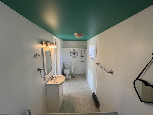 bathroom featuring toilet, vanity, and tile patterned flooring