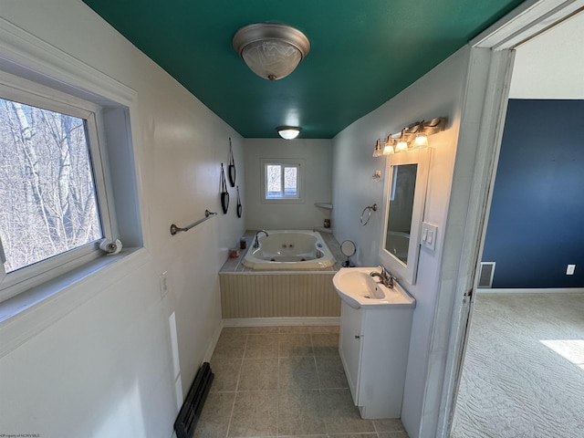 full bathroom with vanity, visible vents, baseboards, tile patterned flooring, and a jetted tub
