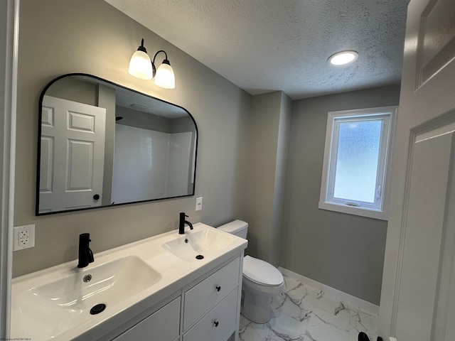 bathroom featuring marble finish floor, toilet, baseboards, and a sink