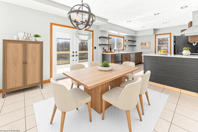 dining room with light tile patterned floors, baseboards, recessed lighting, french doors, and a chandelier