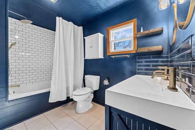 bathroom featuring vanity, a textured ceiling, tile patterned floors, toilet, and tiled shower / bath