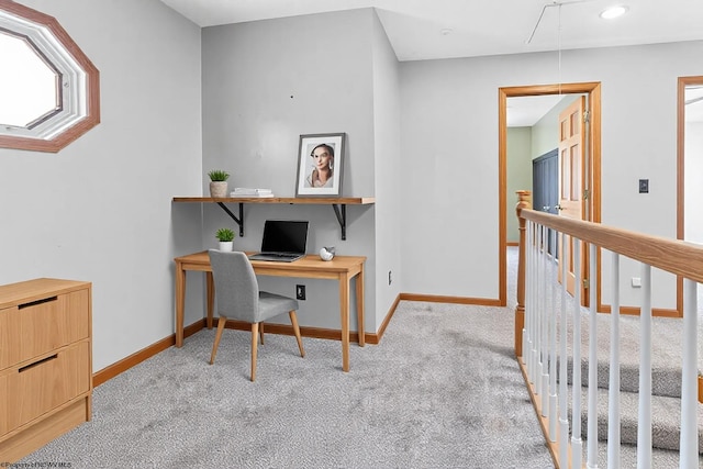 office area featuring light colored carpet, attic access, and baseboards