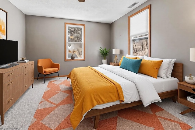 bedroom with visible vents and light colored carpet