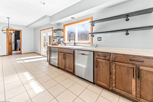 kitchen featuring light tile patterned floors, dishwasher, open shelves, and a sink