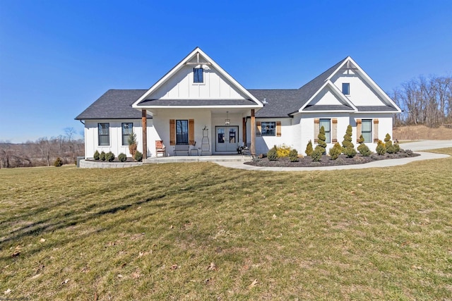 modern farmhouse featuring a front yard and board and batten siding