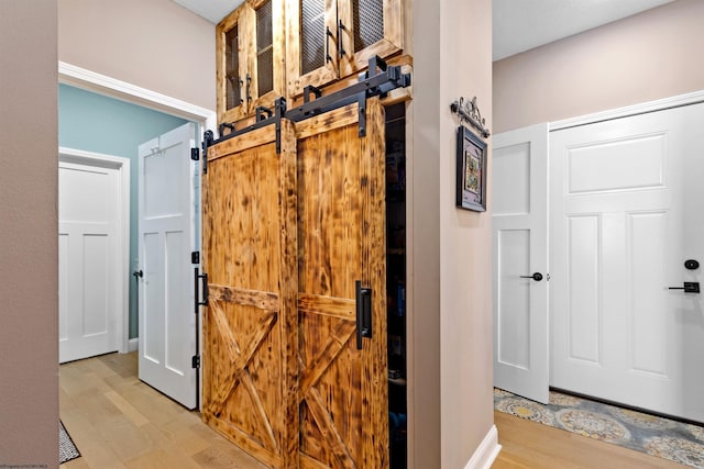 interior space featuring a barn door and light wood-type flooring