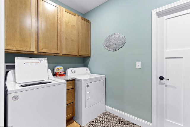 laundry room featuring cabinet space, independent washer and dryer, and baseboards