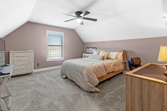 carpeted bedroom featuring lofted ceiling, a ceiling fan, and baseboards