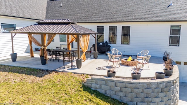 view of patio featuring a gazebo, area for grilling, and a fire pit