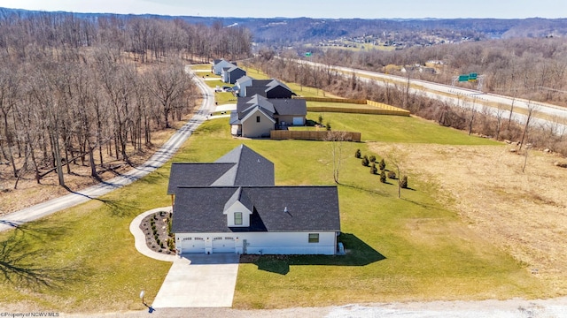 birds eye view of property featuring a wooded view