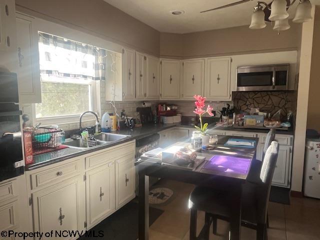 15401/2 Country Club Rd, Fairmont, WV 26554 - kitchen with stainless steel microwave, a sink, a chandelier, and backsplash