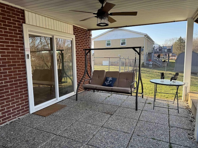 view of patio featuring a ceiling fan and fence