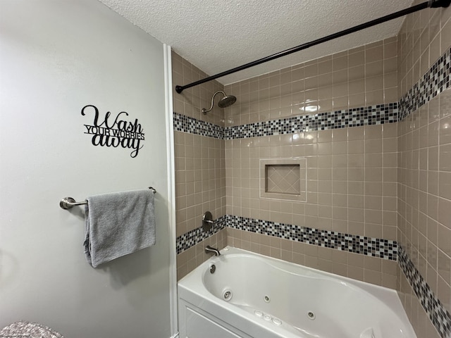 full bathroom featuring a textured ceiling and a combined bath / shower with jetted tub