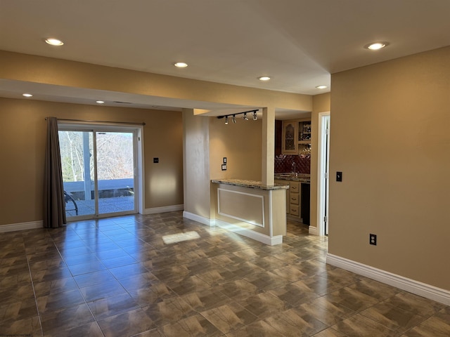 unfurnished living room featuring recessed lighting and baseboards