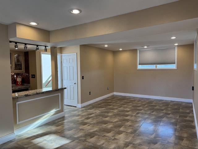 interior space with track lighting, recessed lighting, and baseboards