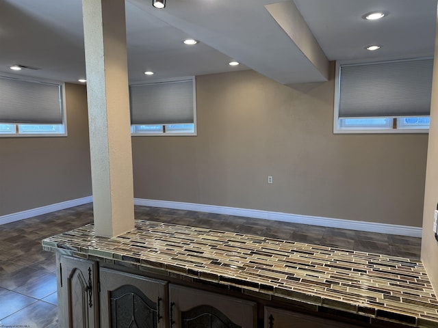 basement featuring recessed lighting and baseboards