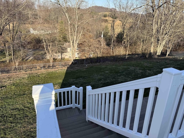 wooden deck with a lawn and fence