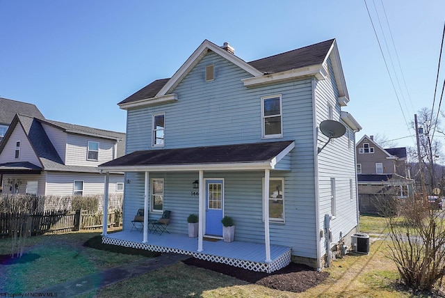 rear view of property with a porch, central AC, and fence