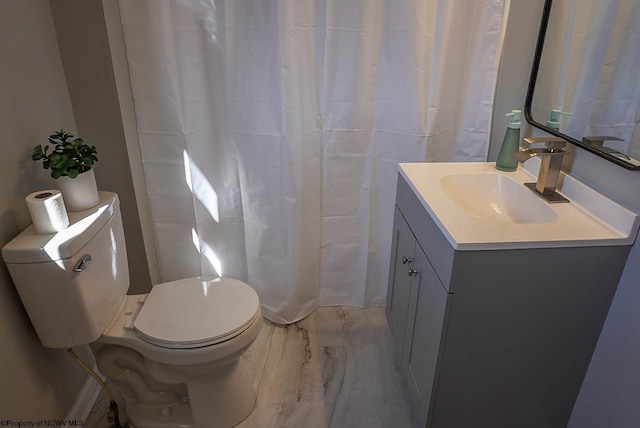 bathroom featuring marble finish floor, toilet, and vanity