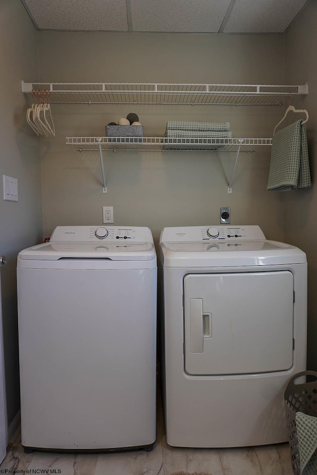 clothes washing area featuring washing machine and dryer and laundry area