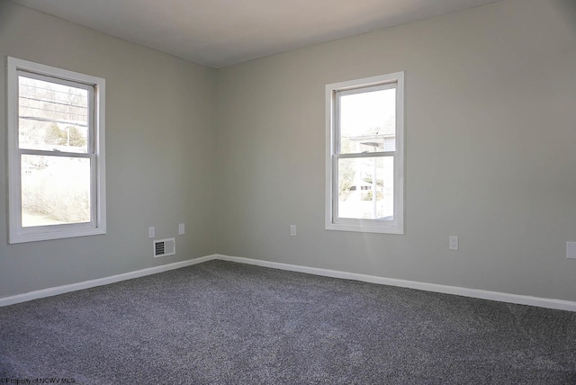 unfurnished room featuring carpet flooring, baseboards, and visible vents