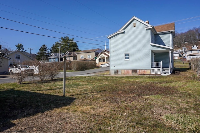 view of home's exterior with fence, a lawn, a residential view, and a chimney