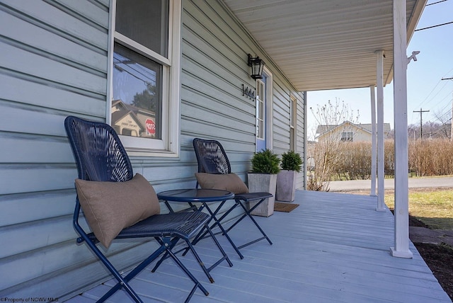 wooden terrace with a porch