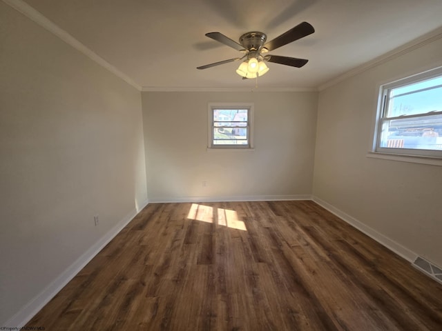 unfurnished room with dark wood-style floors, crown molding, and baseboards