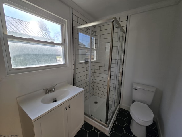 bathroom with vanity, tile patterned floors, toilet, and a stall shower