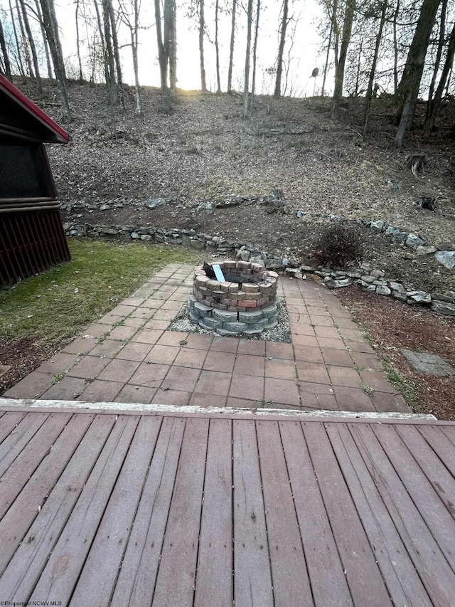 wooden deck featuring a patio and a fire pit