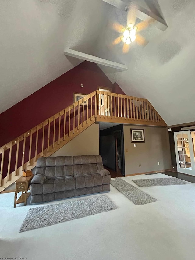 living area featuring lofted ceiling, stairway, and concrete floors